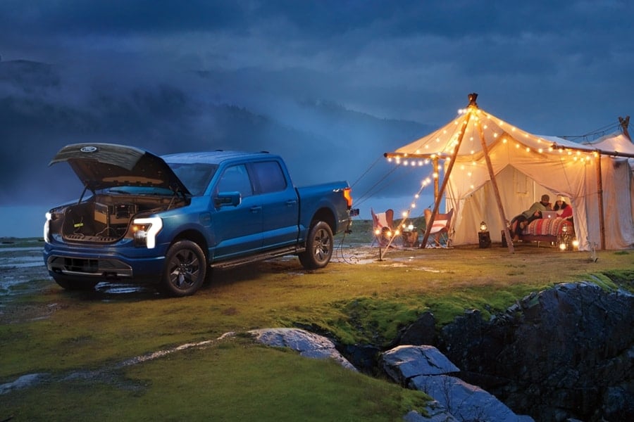 Ford F-150 Lightning lighting a tent outside